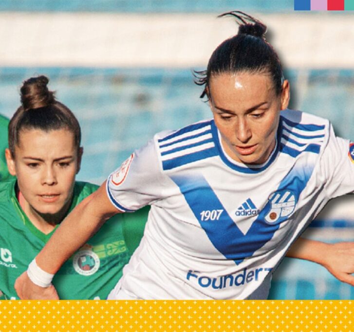 Two women playing soccer.