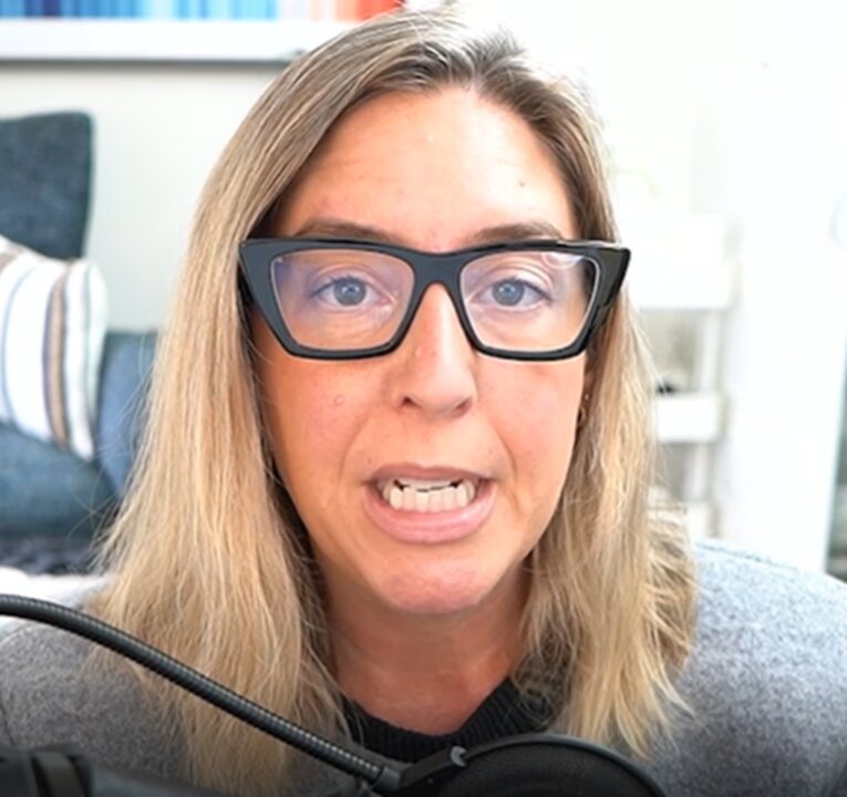 Woman talking into her computer.